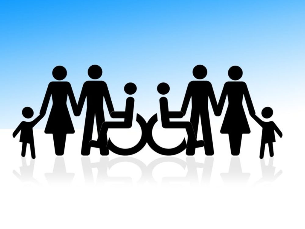 People holding hands including those in wheelchairs