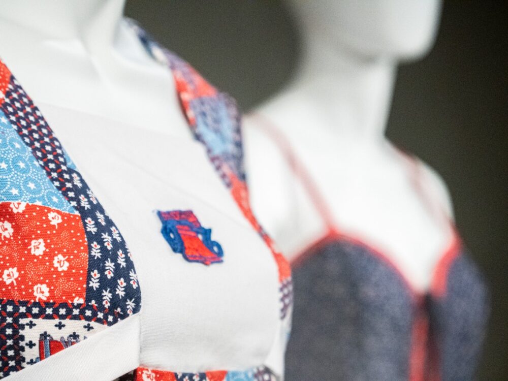 Close up of two mannequins wearing red, white, and blue dresses