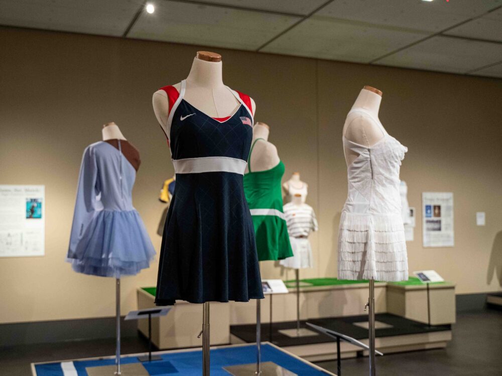 A wide view of the Courting Style exhibit featuring 4 dress forms with garments.