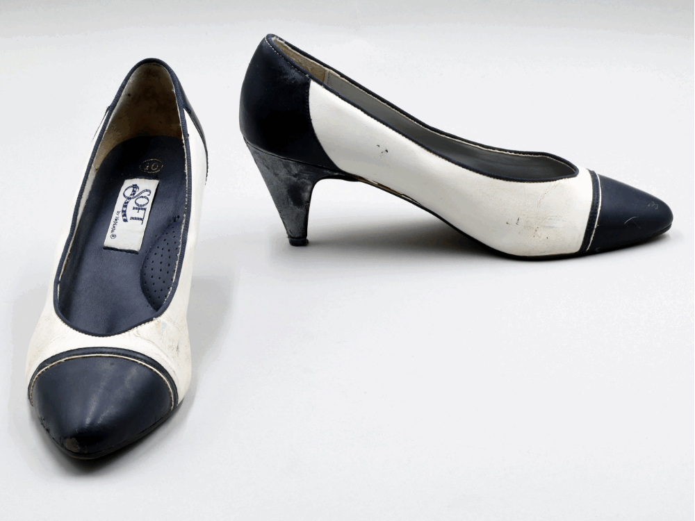 A pair of white and navy heeled shoes.