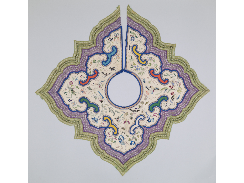 An image of a Chinese cloud collar that features bands of ribbon on the exterior, and a heavily embroidered interior.