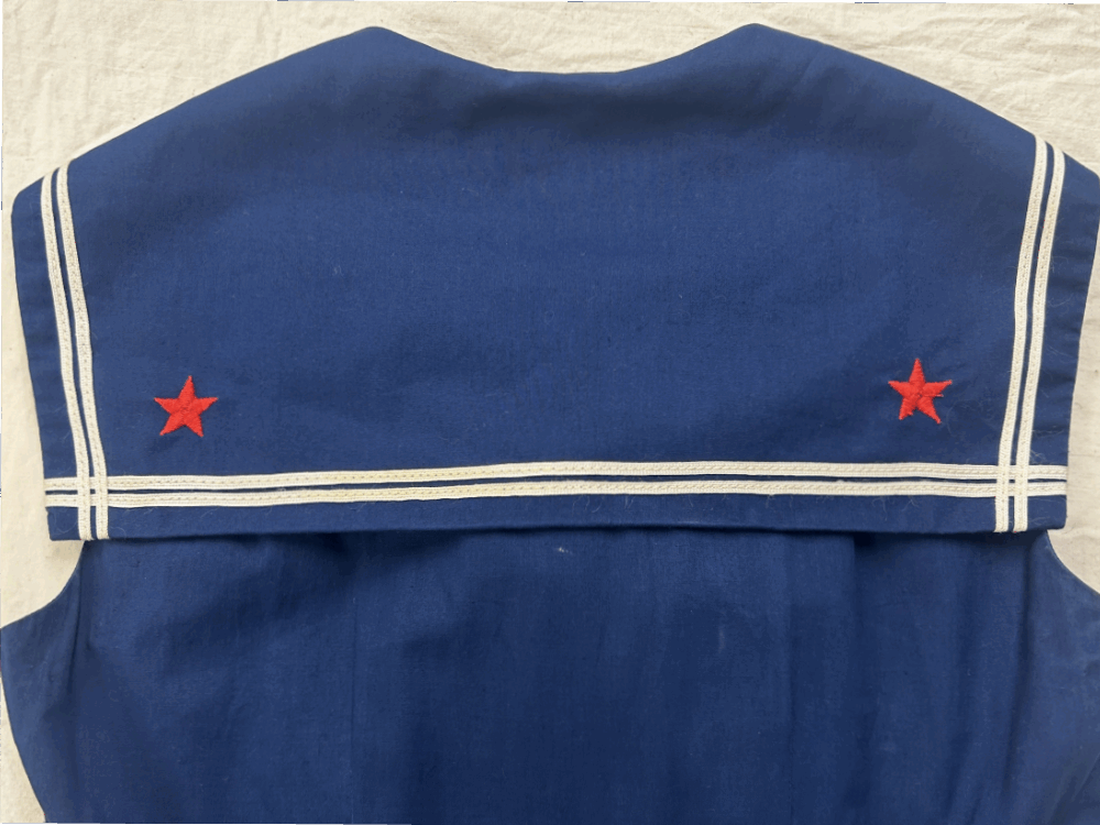 A detail image of a sailor collar on a woman's dress.
