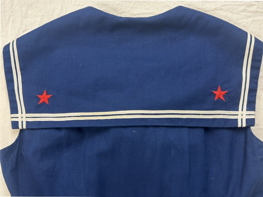 A detail image of a sailor collar on a woman's dress.
