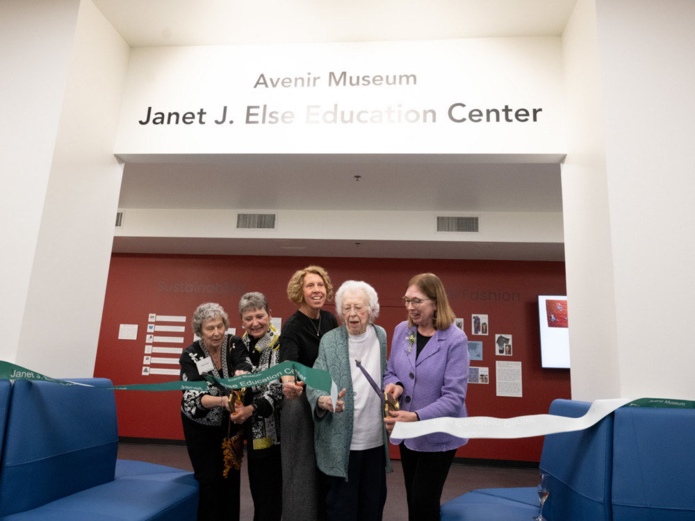 Five women stand beneath an archway to cut the ribbon for the new Janet J. Else Education Center.