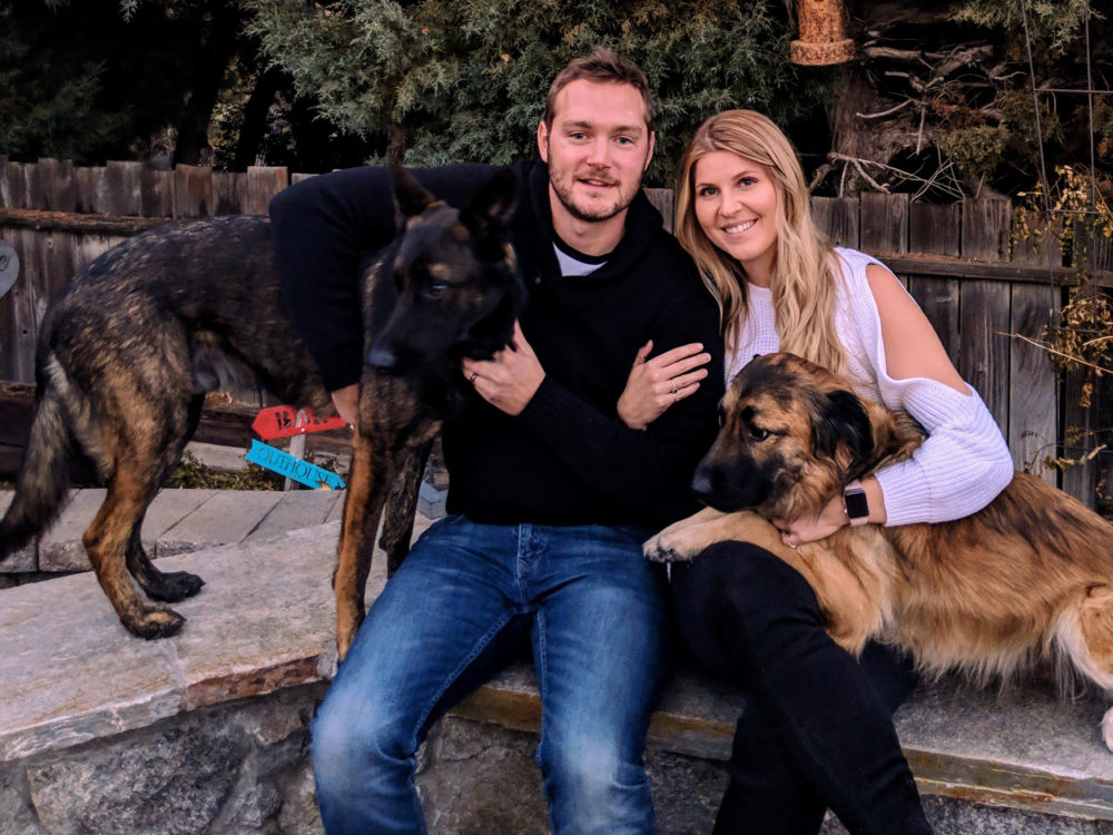 Brett pictured with his girlfriend and their two dogs