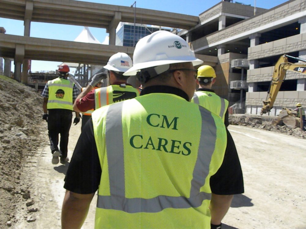 Workers in CM Cares vests on a construction site