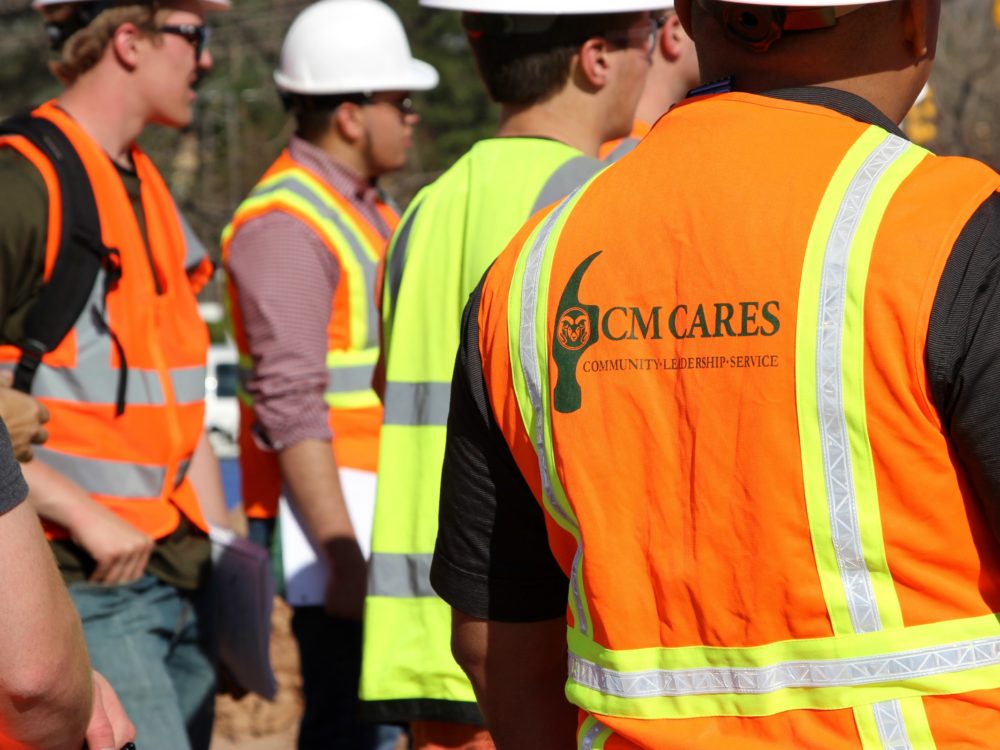 CM Cares logo on back of vest of construction worker on jobsite