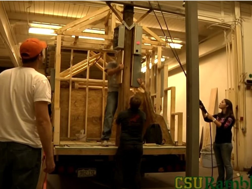Students framing a building on the CM float for homecoming inside the IS Lab