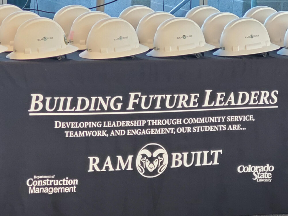 CM Hard Hats on black tablecloth that says, `Building Future Leaders` - RamBuilt