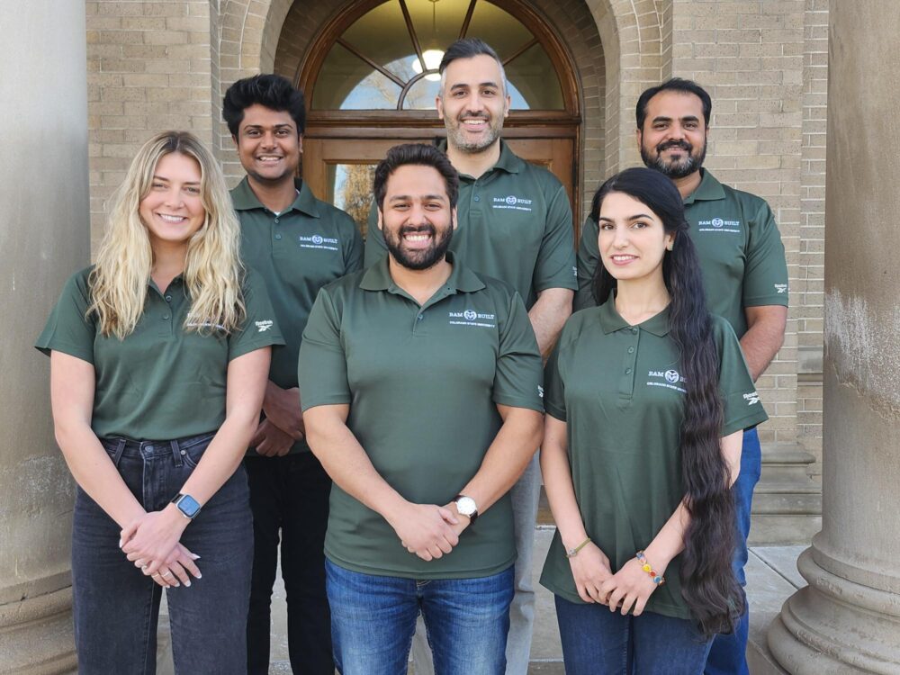 A photo of the integrated project team, including six members, all wearing matching green polos