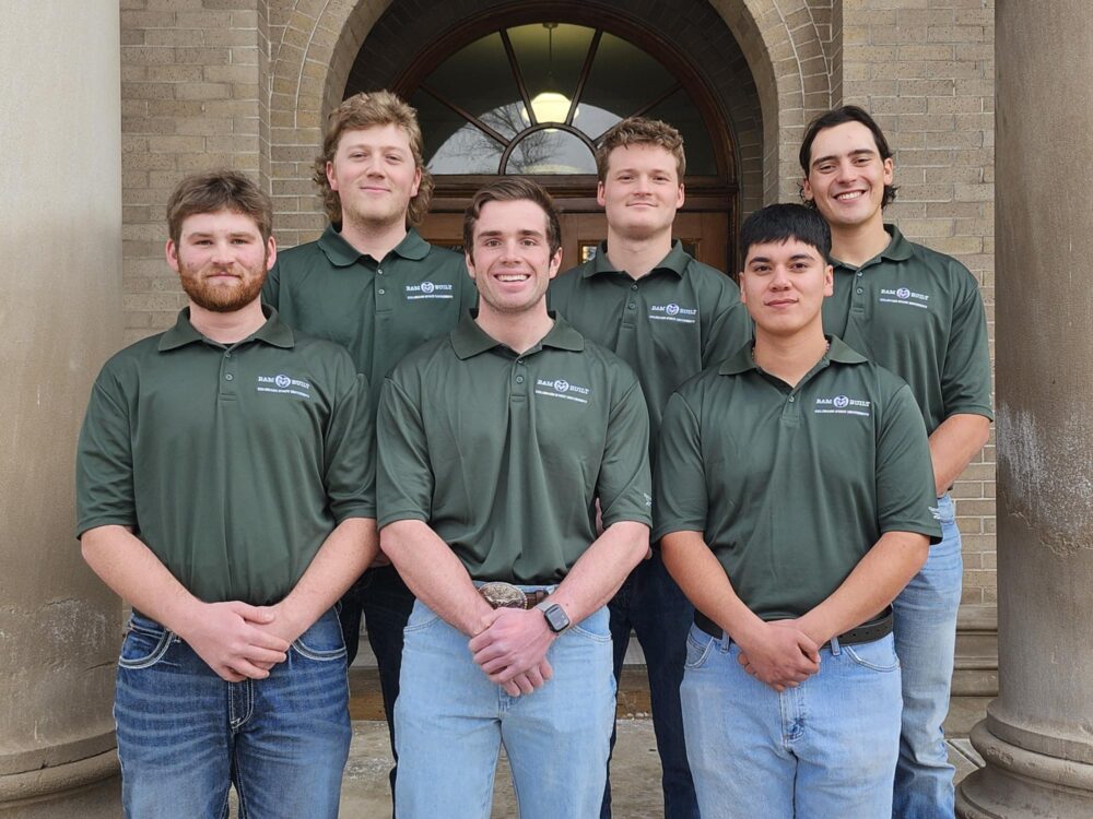 A photo of the preconstruction team, including six members, all wearing matching green polos