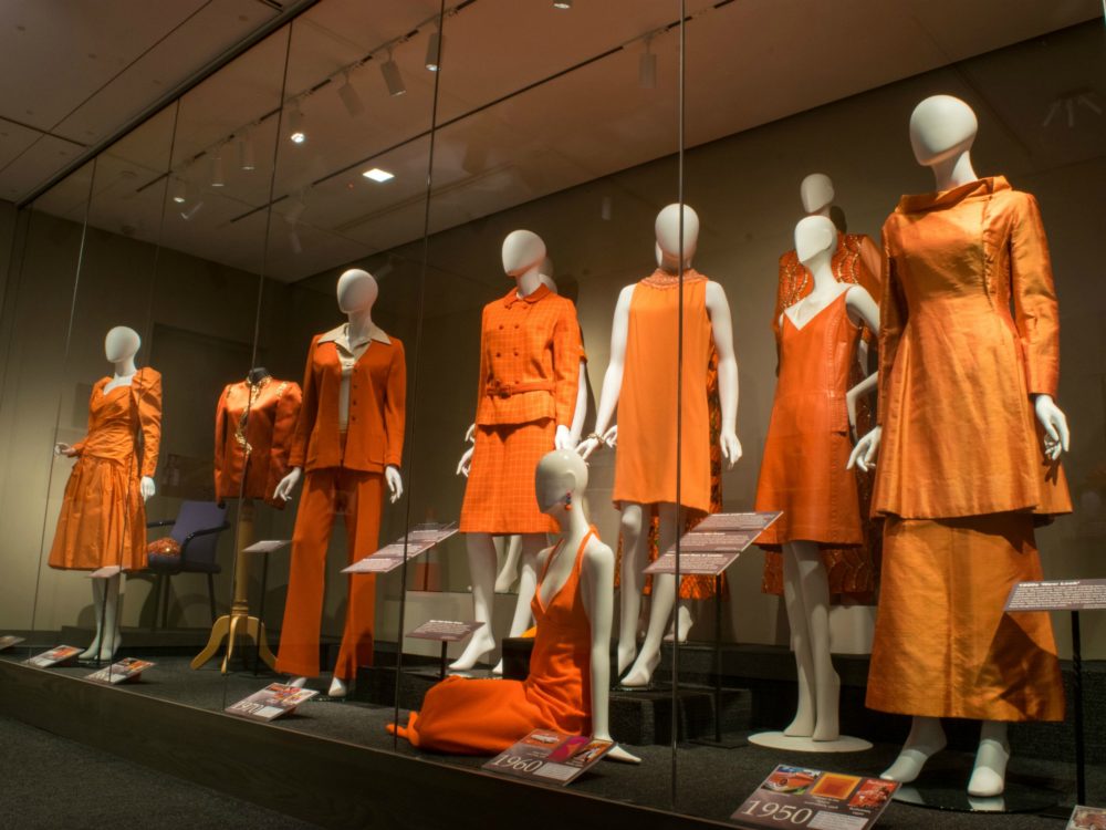 Avenir Museum exhibit featuring orange garments