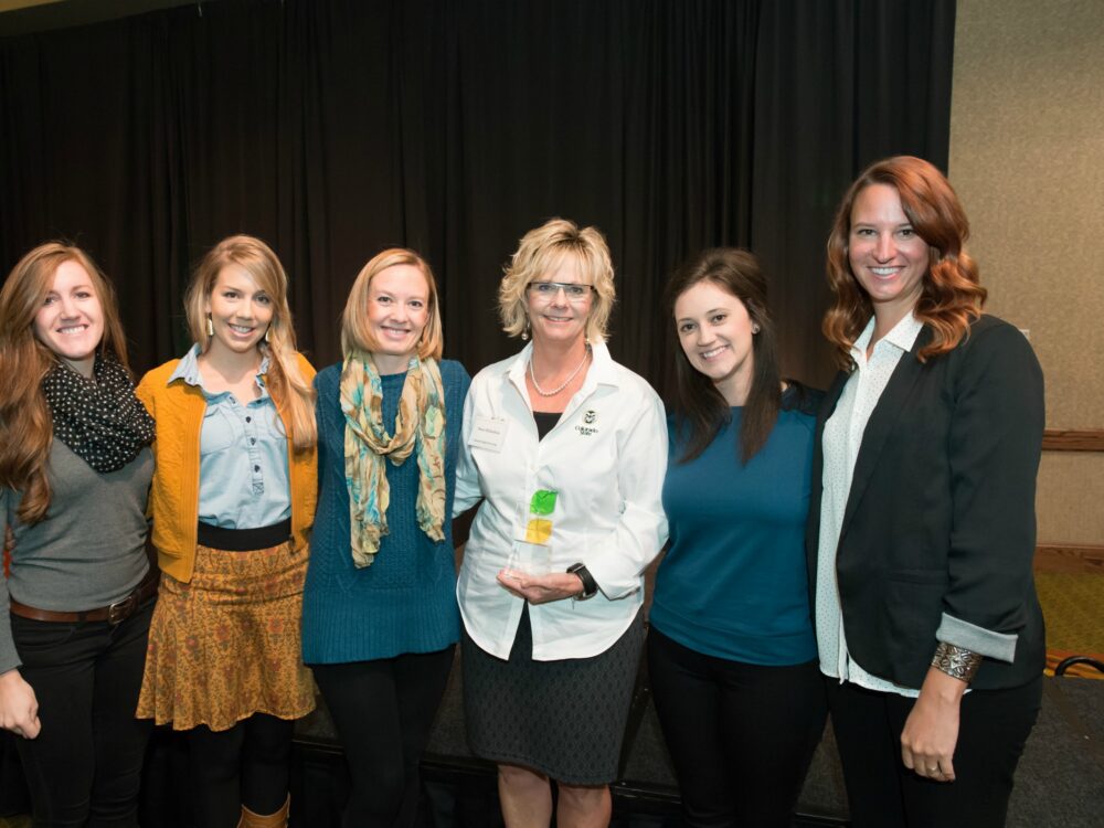 Nancy Richardson with alumni award and colleagues