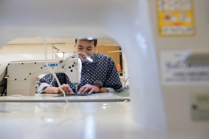 Student operating a sewing machine