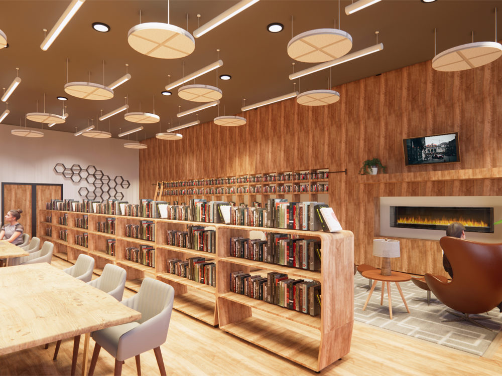 The Missing Piece facility seating area featuring fireplace seating area, library, book shelves, round lighting and hexagonal accent art piece.
