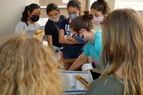 Students examine items in the Avenir Museum