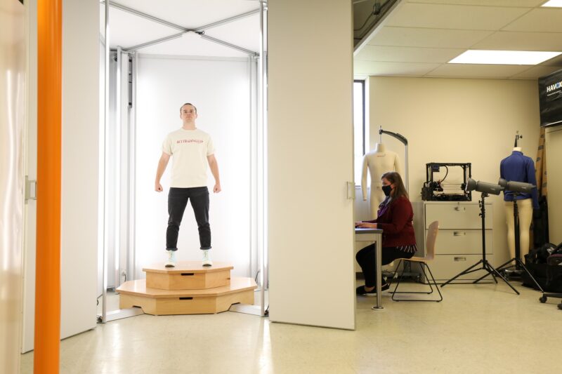 a fit model stands in a 3D body scanner in a research lab to collect data as a part of earning an M.S. in Design and Merchandising