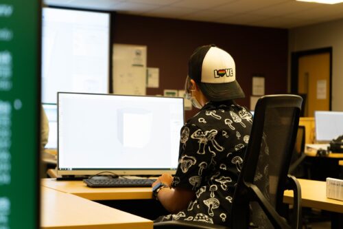 A student works on store design at their computer