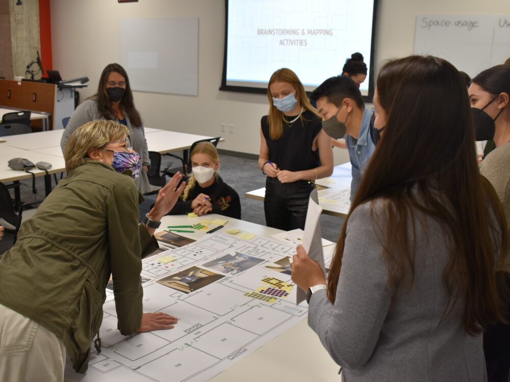 Visioning session for IAD students reviewing floor plans