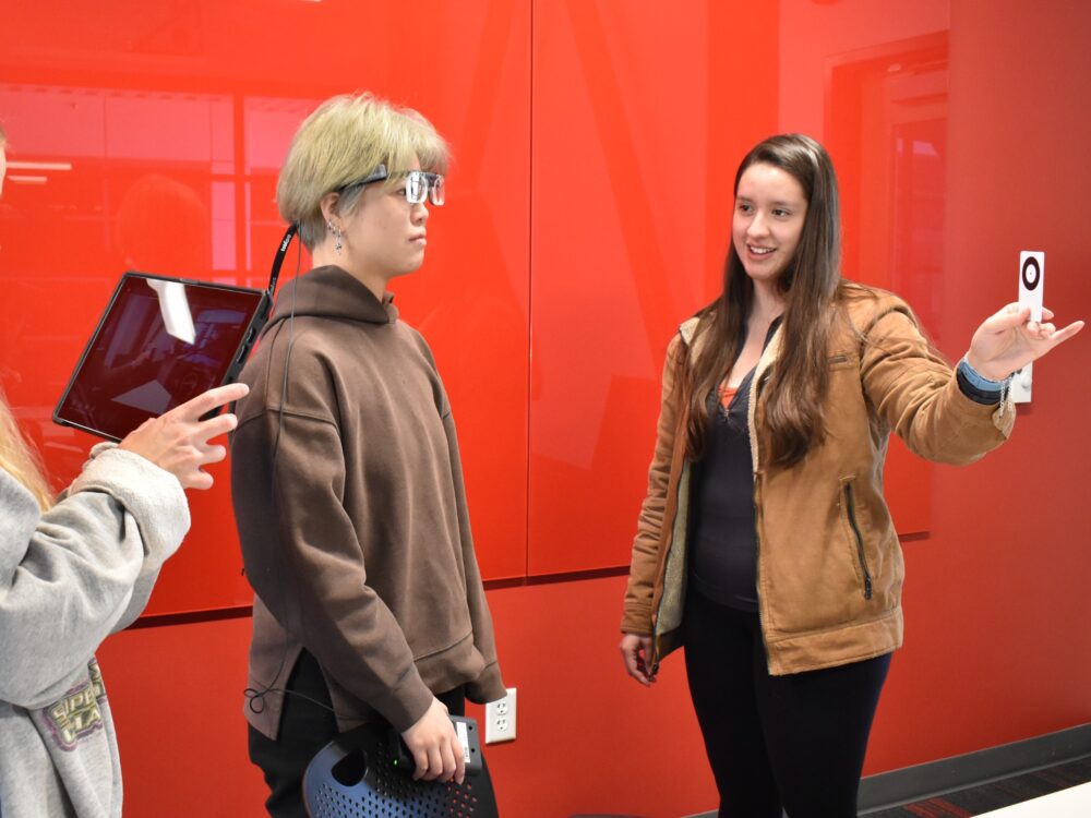 A group of three students use eye-tracking technology for interior design research