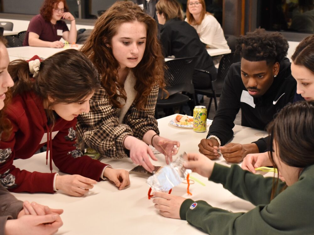 A group of students build a structure during an IIDA Student organization meeting