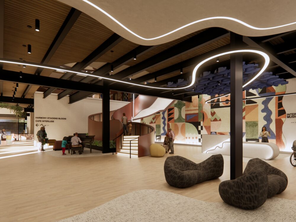 Creative community interior featuring wavy ceiling lighting, a bold geometric mural, curved staircases, and flexible lounge seating throughout.