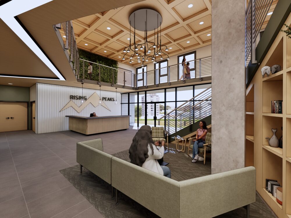 Modern double‑height lobby with wood‑paneled ceilings, a central chandelier, open stairway, shelving displays, and a reception desk labeled “Rising Peaks.”