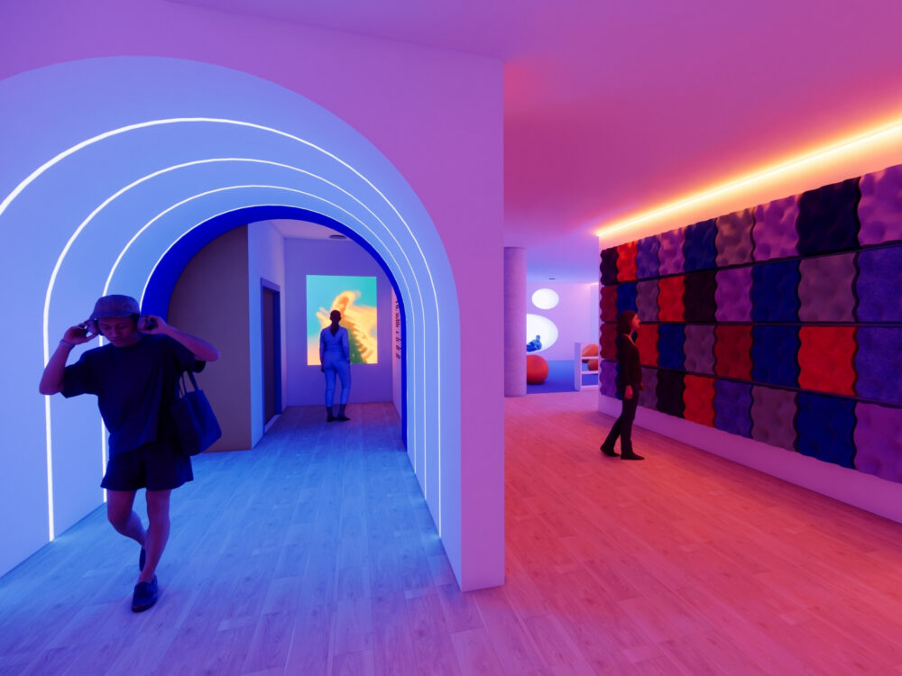 A vibrant, immersive hallway with glowing blue LED arches, colorful wall panels, and ambient lighting leading into gallery‑like rooms.