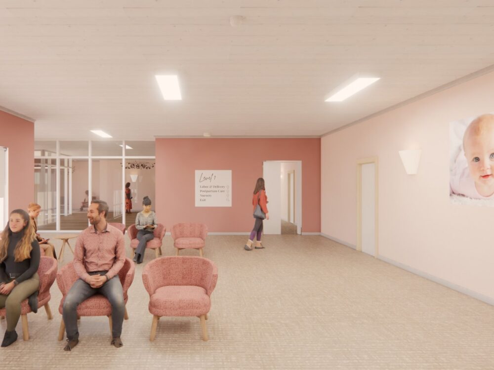 A soft pink waiting room with cozy lounge chairs, wall art, and a corridor leading to additional rooms in a calming clinic environment.