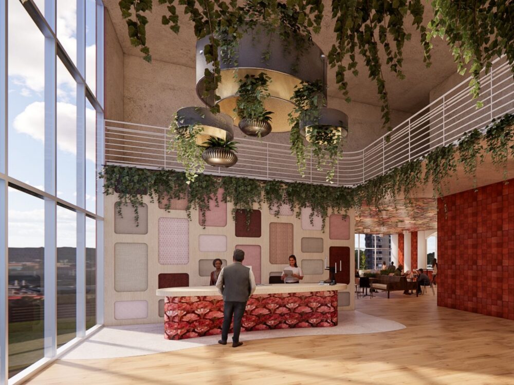 A vibrant hotel-style reception area with hanging greenery, layered pendant lights, a textured accent wall, and a stone-patterned front desk beside floor‑to‑ceiling windows.