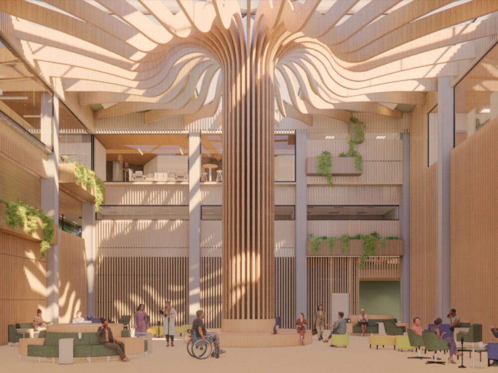 A sun‑filled multi‑story atrium with a massive branching wooden column, vertical slatted walls, green seating clusters, and planters integrated across multiple levels.
