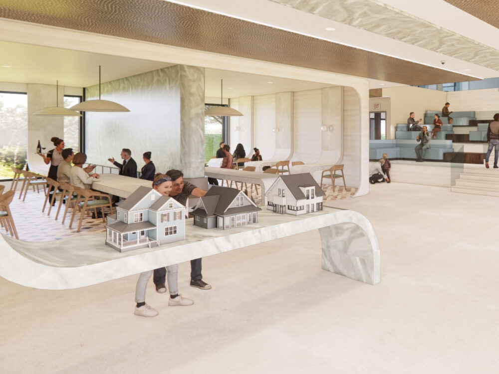 A collaborative design studio featuring a sculptural display table holding scaled house models, adjacent workspaces, and tiered seating steps for group discussion.