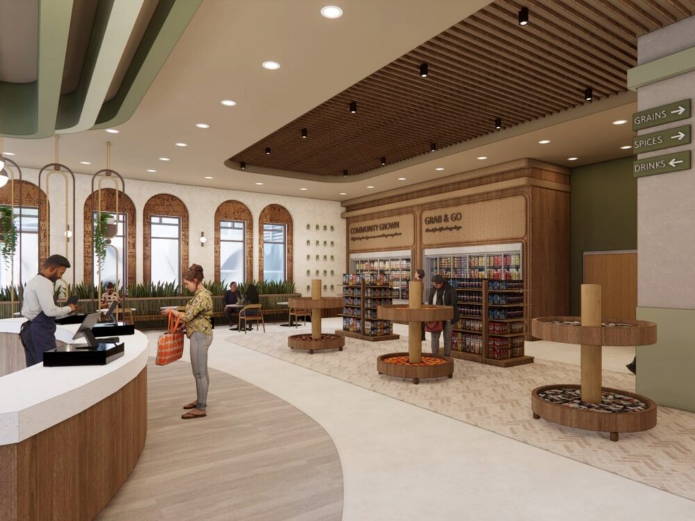 A warm, natural‑toned market interior with arched windows, wood ceilings, produce and snack displays, and a checkout counter along a curved pathway.