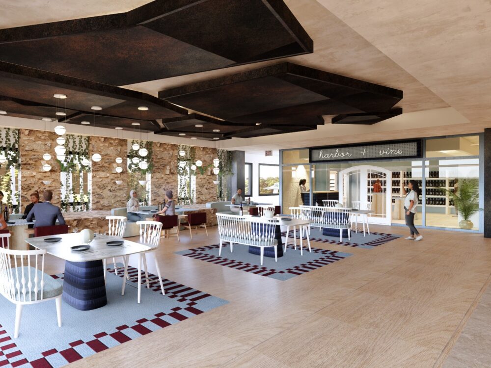 A bright coastal‑style restaurant with patterned rugs, white wood chairs, stone accent walls, and a counter labeled “tapas + wine” beside casual dining tables.