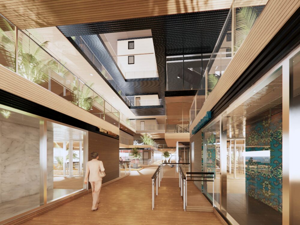 A modern indoor retail concourse with wood ceilings, greenery, glass storefronts, and upper‑level walkways connected by open atrium spaces.