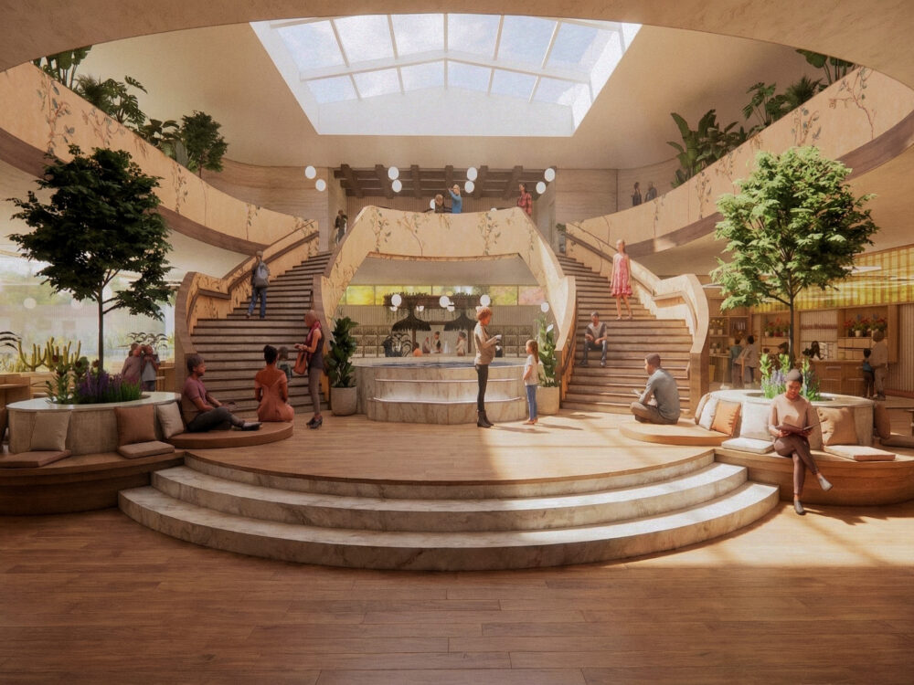 A grand wellness atrium with twin staircases, a skylight, indoor trees, circular lounge seating, and people gathering around a central fountain feature.