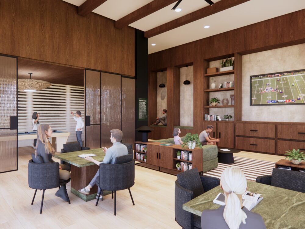 A cozy lounge with wood-paneled walls, green stone tables, bookshelves, and a large TV as people read, talk, and relax across multiple seating areas.