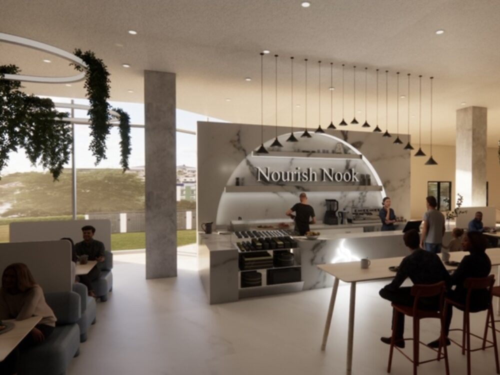 A modern café space with a marble counter labeled “Nourish Nook,” pendant lights, integrated greenery, and seating facing tall windows.
