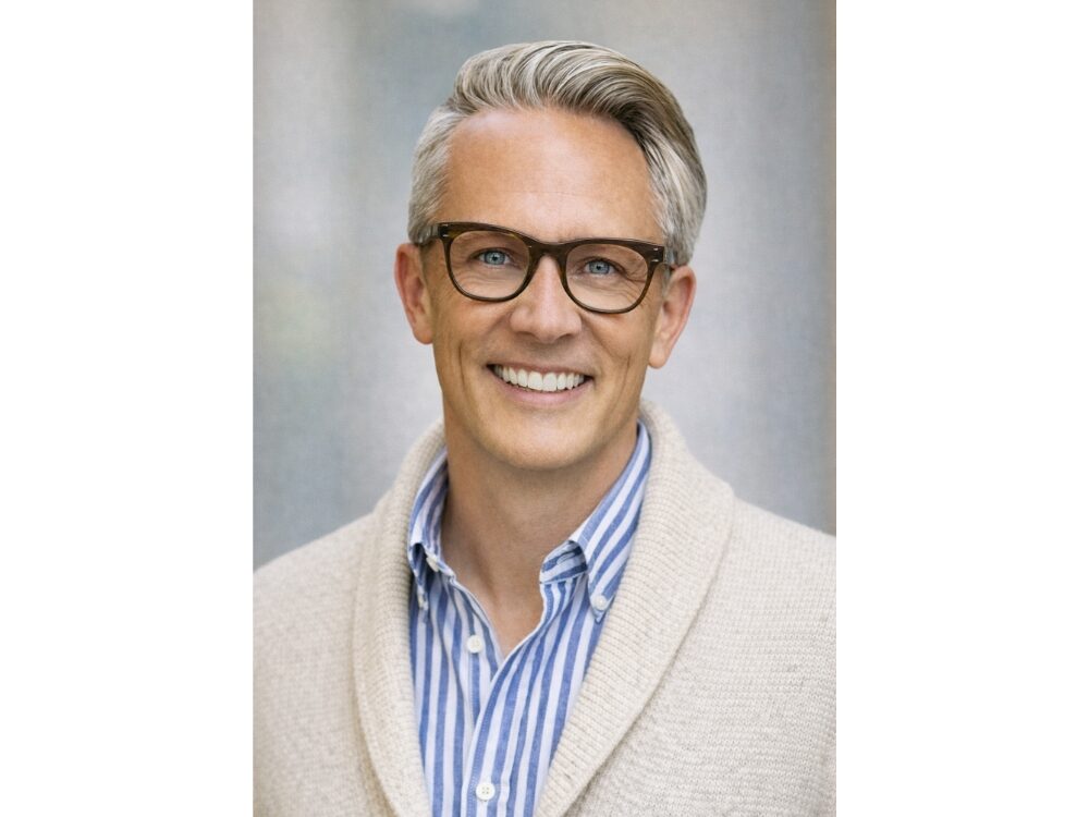 Portrait of Heath Olson in front of a gray backdrop.