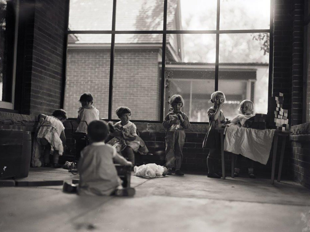Children play on porch at 212 W Laurel July 18, 1928