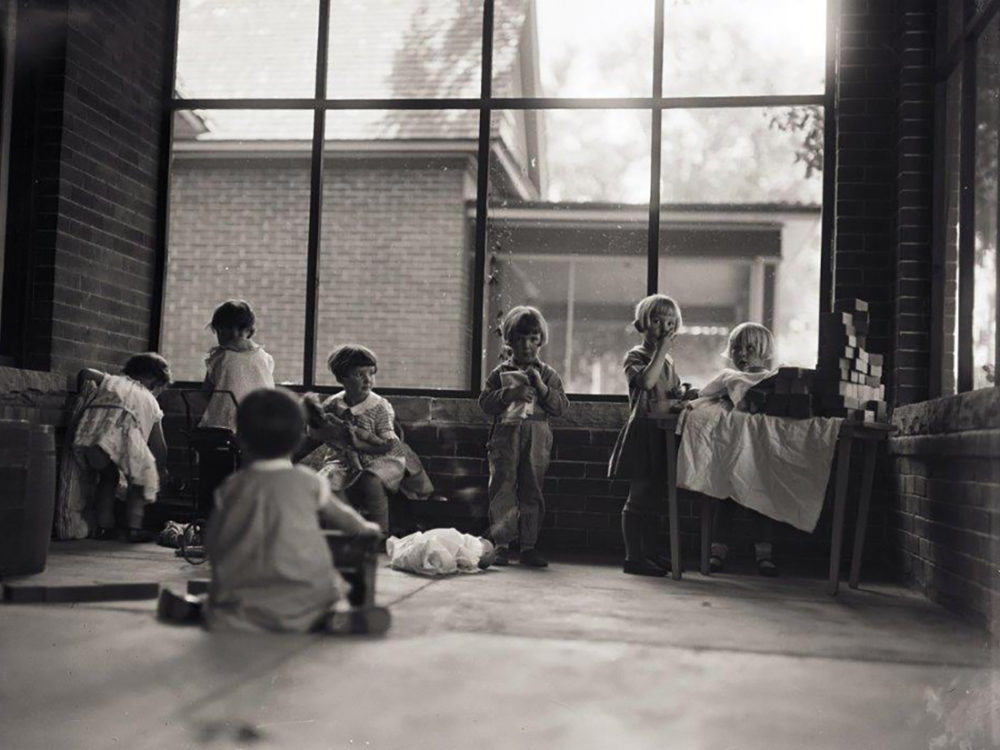 Children play on porch at 212 W Laurel July 18, 1928