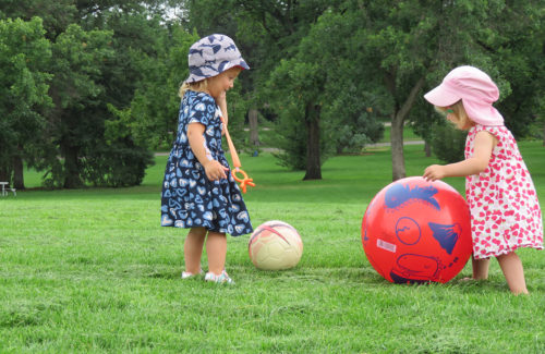 Two children play with a ball at City Park