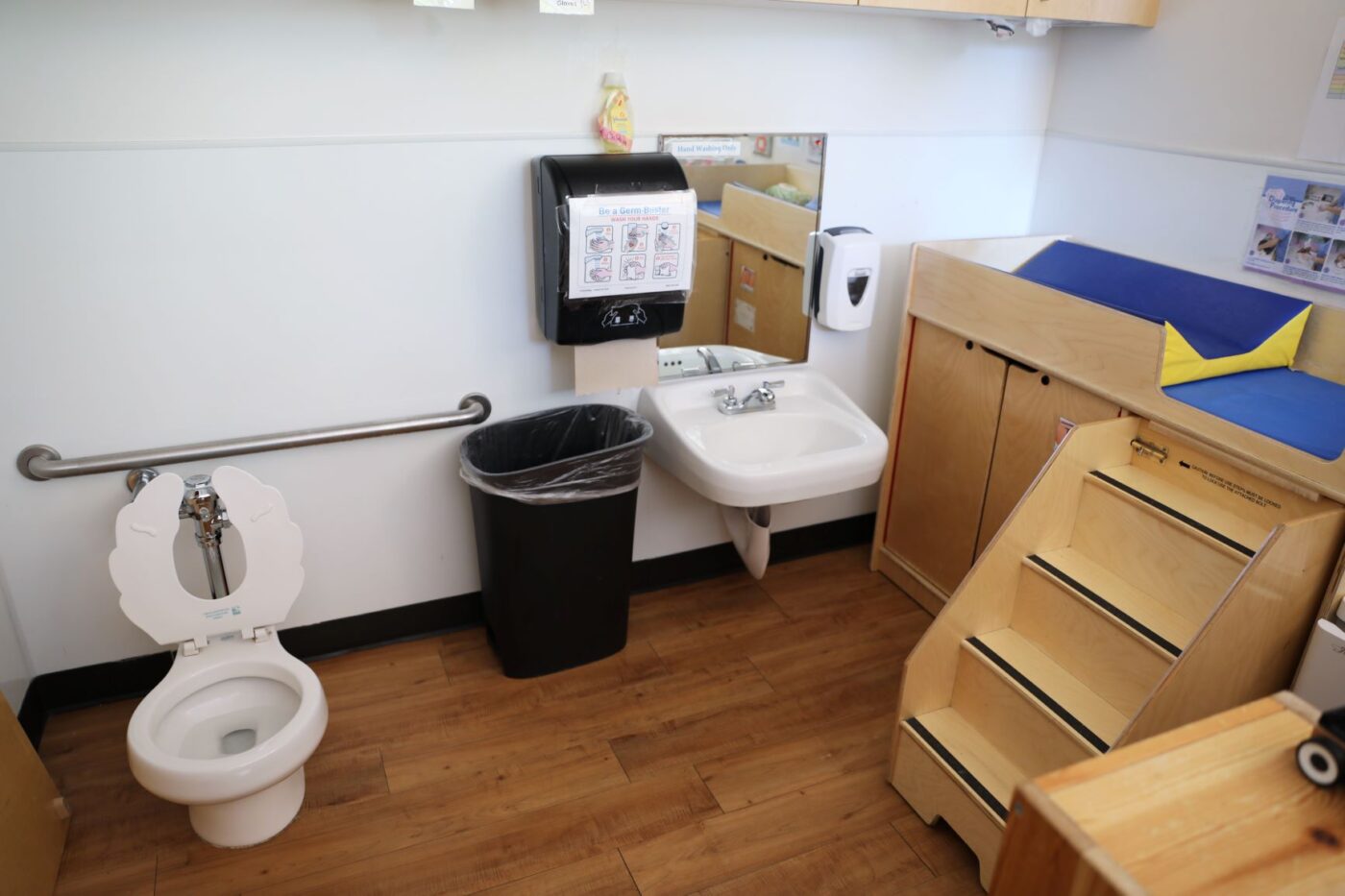ECC 105 bathroom area with small sink, toilet, and changing table