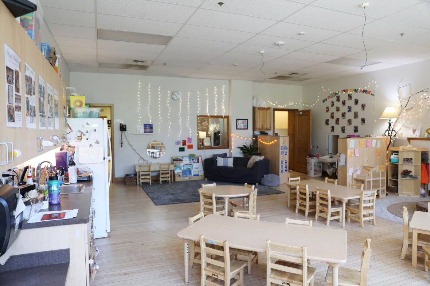 ECC room with small tables, a fridge, and a couch