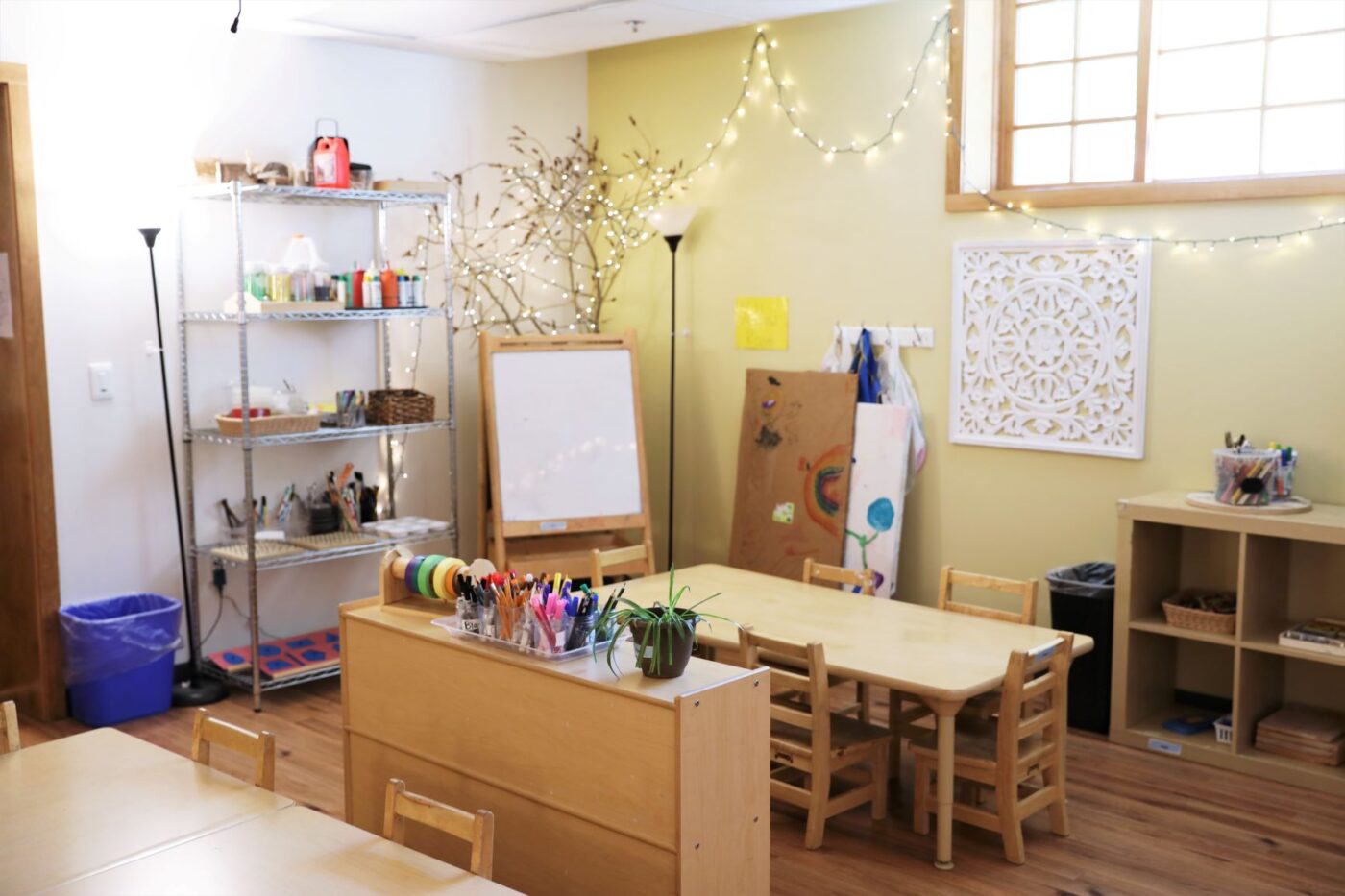 ECC classroom art station with materials, whiteboard, and table