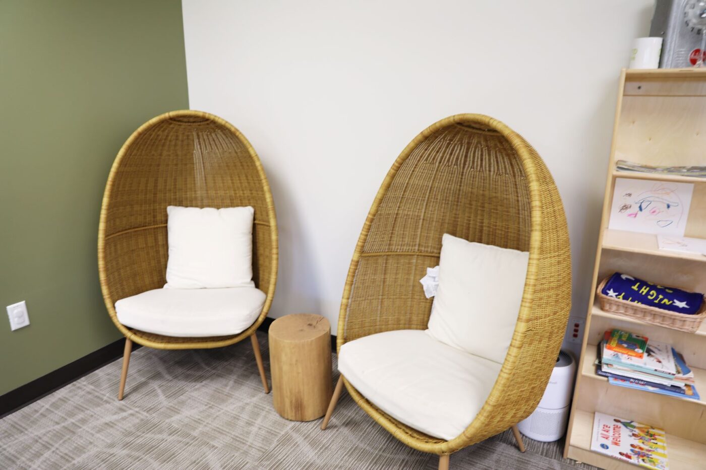 Rounded wicker reading chairs with white cushions
