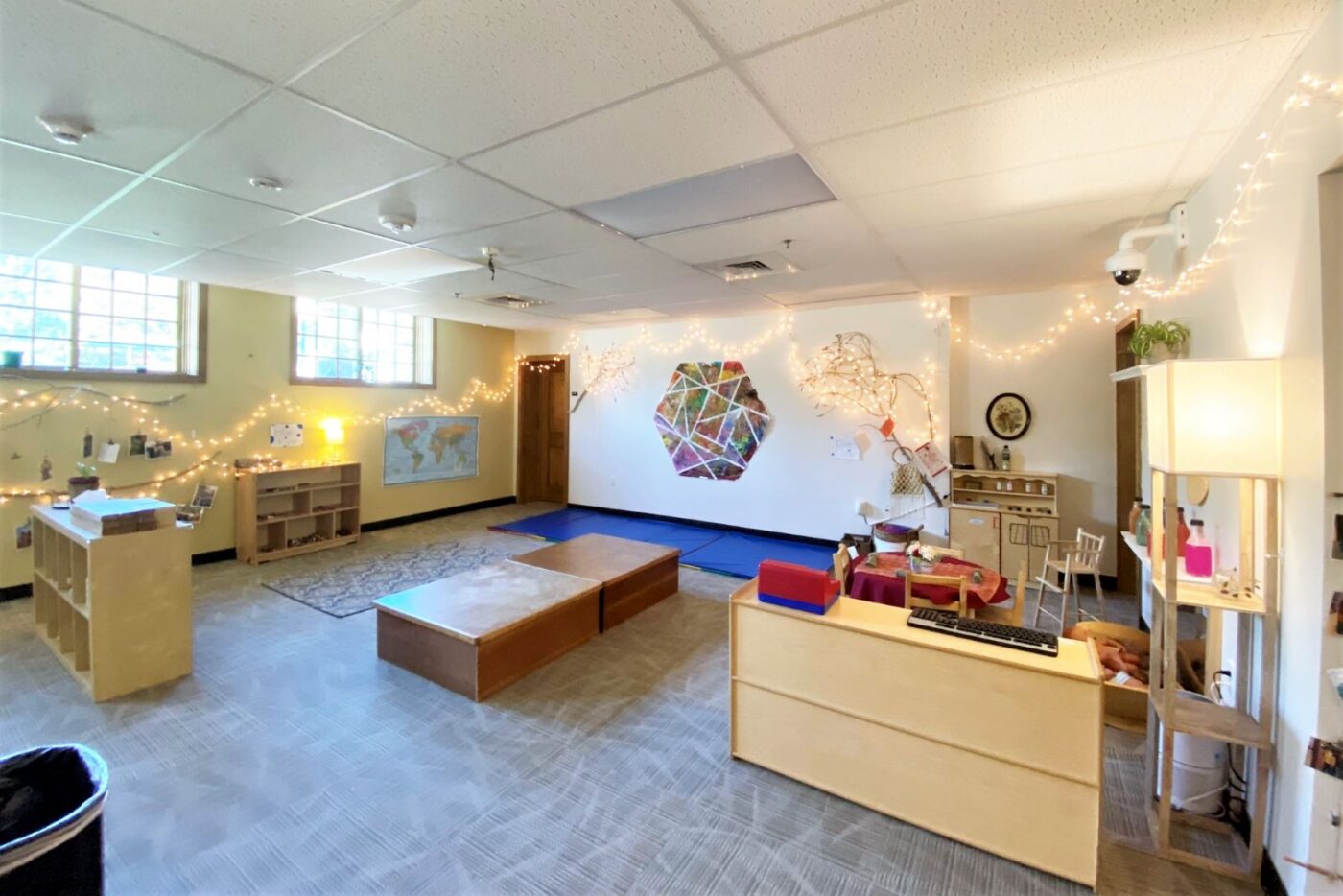 ECC room with twinkle lights, cabinets, and hexagon wall art