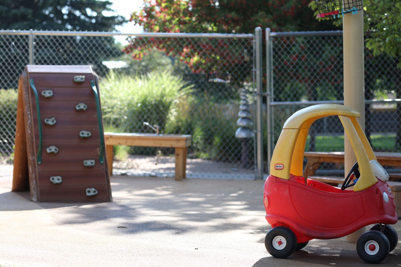 Red and yellow car and a mini climbing area outside