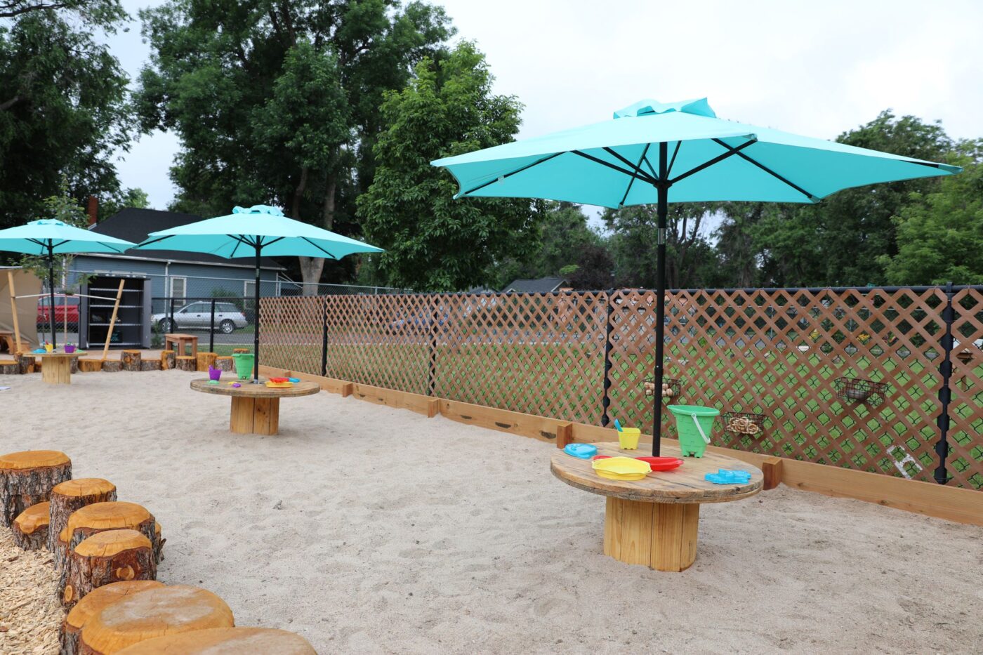 sand pit with umbrellas and sand toys
