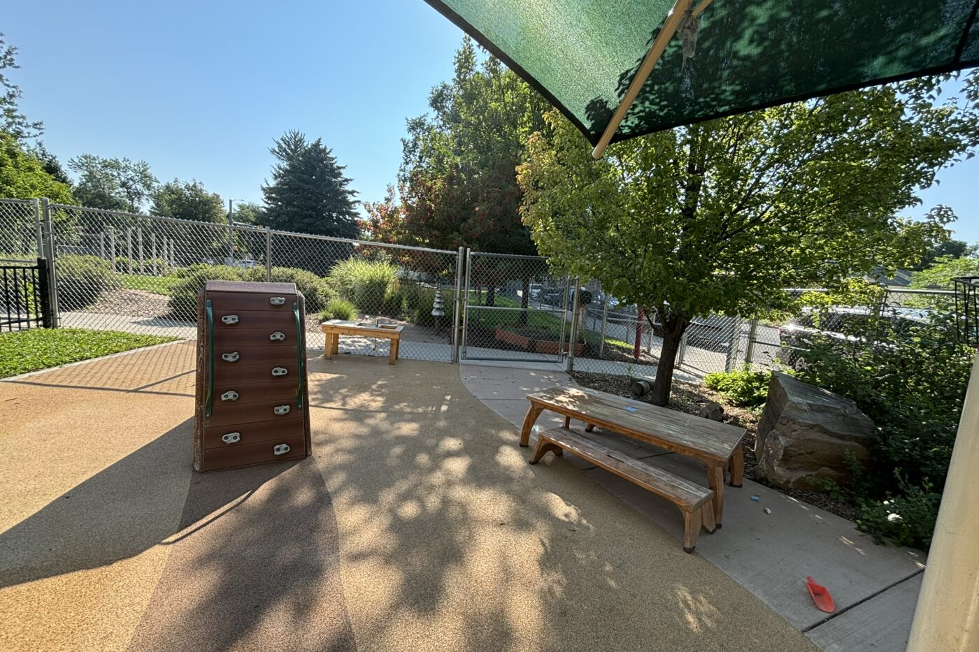 Outdoor play area with mini climbing wall and picnic table